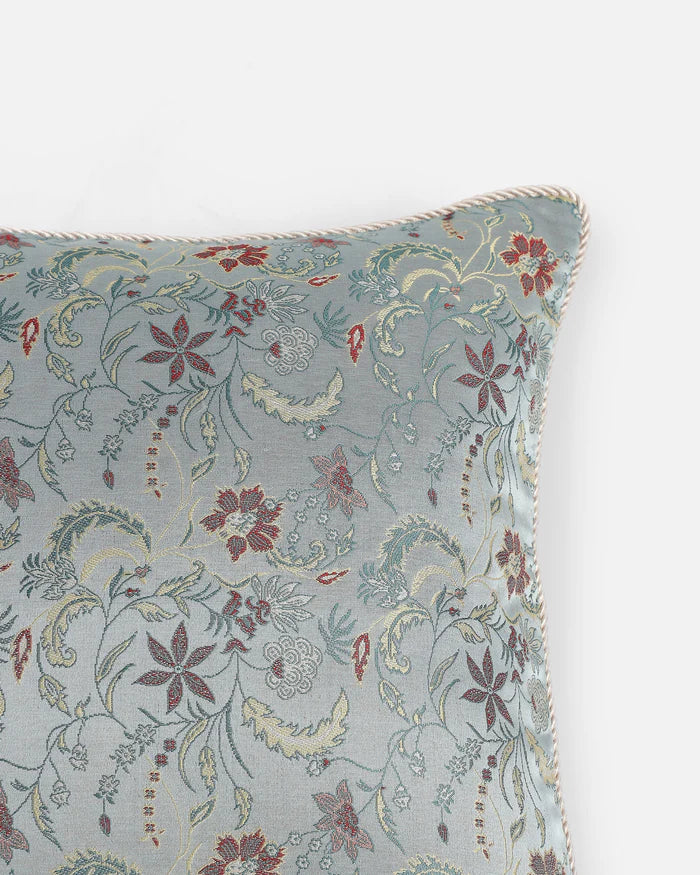 A macro close-up of the handloomed Tanchoi weave, showing the copper silk threads layered into a floral pattern.