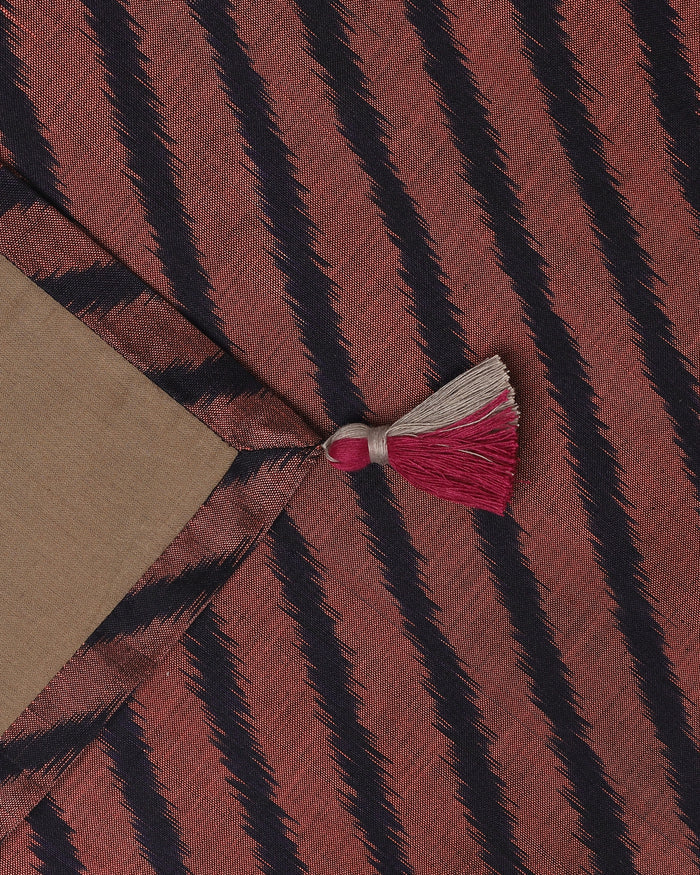 Close-up of the Hearth runner ends featuring sharp black leheriya-style diagonal stripes against a muted rust-red background.