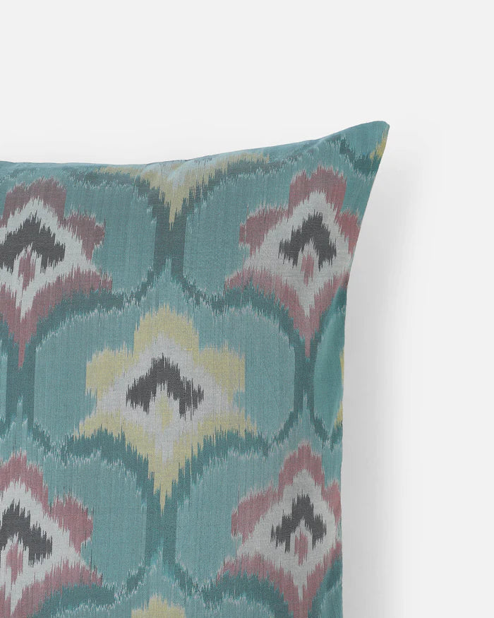 Close-up of authentic Pochampally double ikat weaving in blue, pink, and butter yellow.