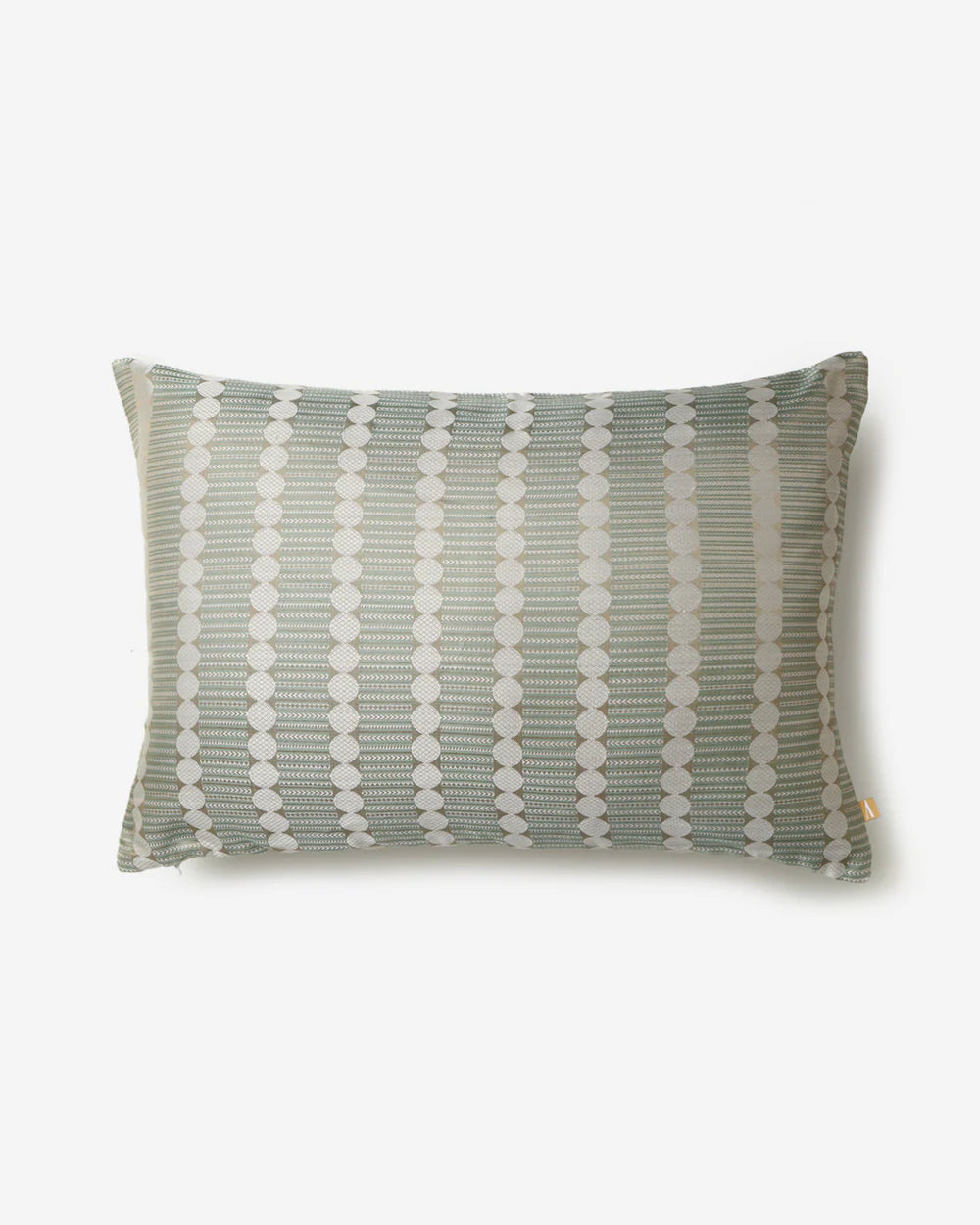 A full studio front view of the Gol pillow showing the rhythmic columns of ivory circles and sage green chevrons.