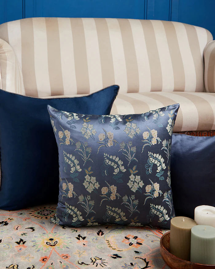 Navy botanical silk pillow styled on a sofa — lifestyle view