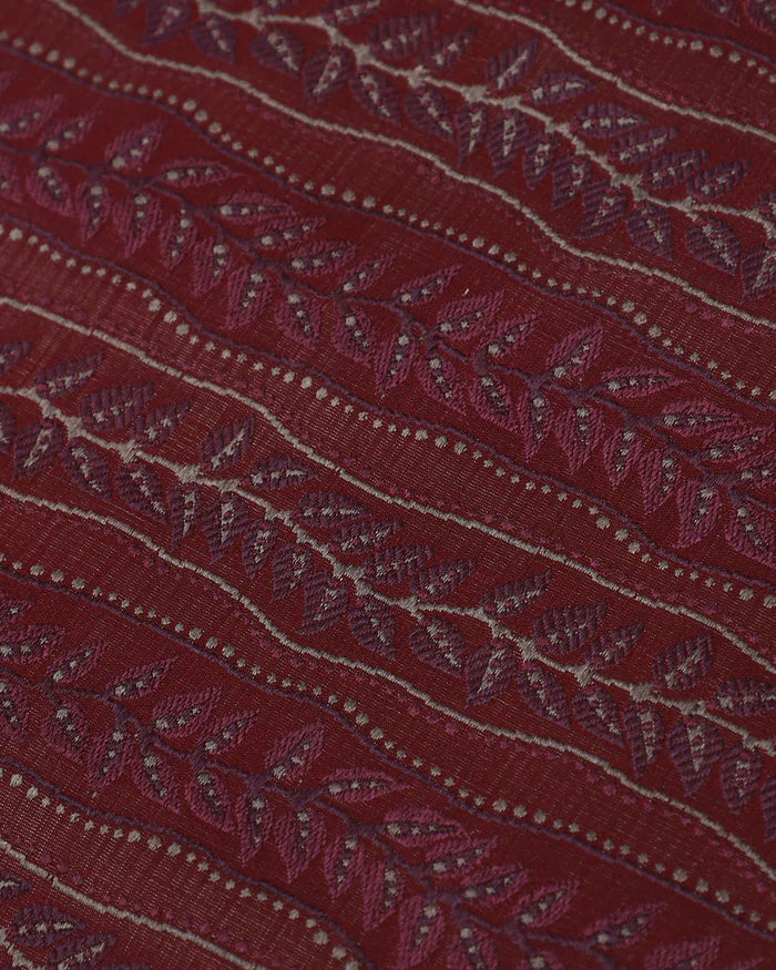 Close detail of vine-and-leaf figuring woven into the red silk, not printed