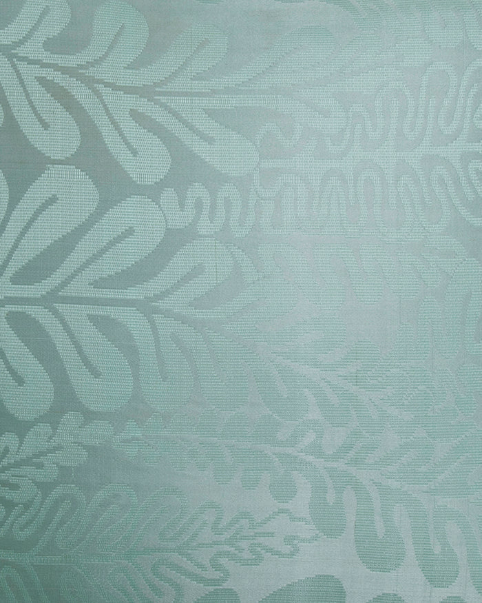 Macro close-up of the luminous seafoam silk, showing the intricate structural weave of the raised fern fronds.