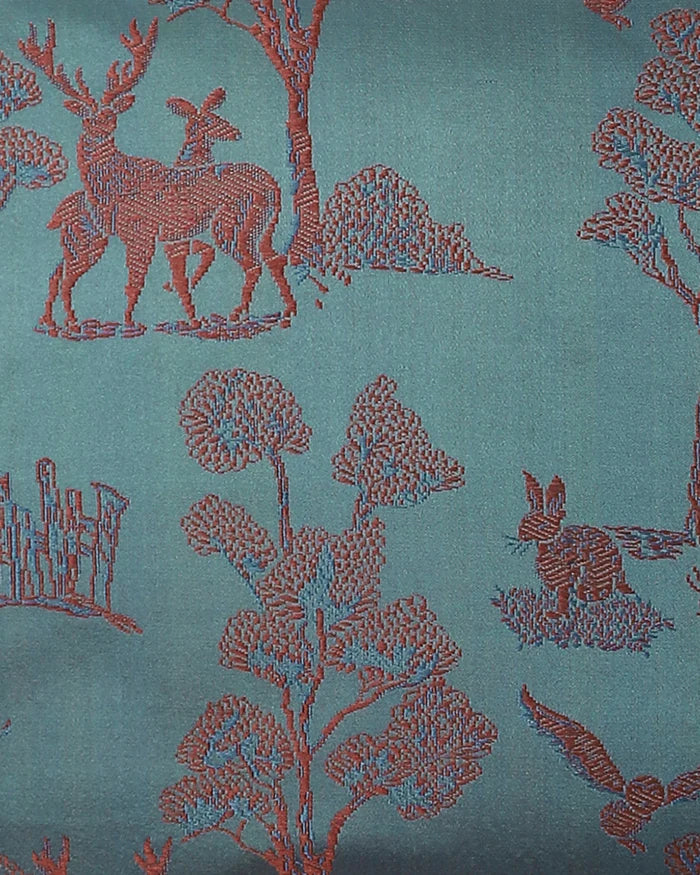 Close-up detail of deer, trees and hares woven into the Tanchoi teal silk, not printed.
