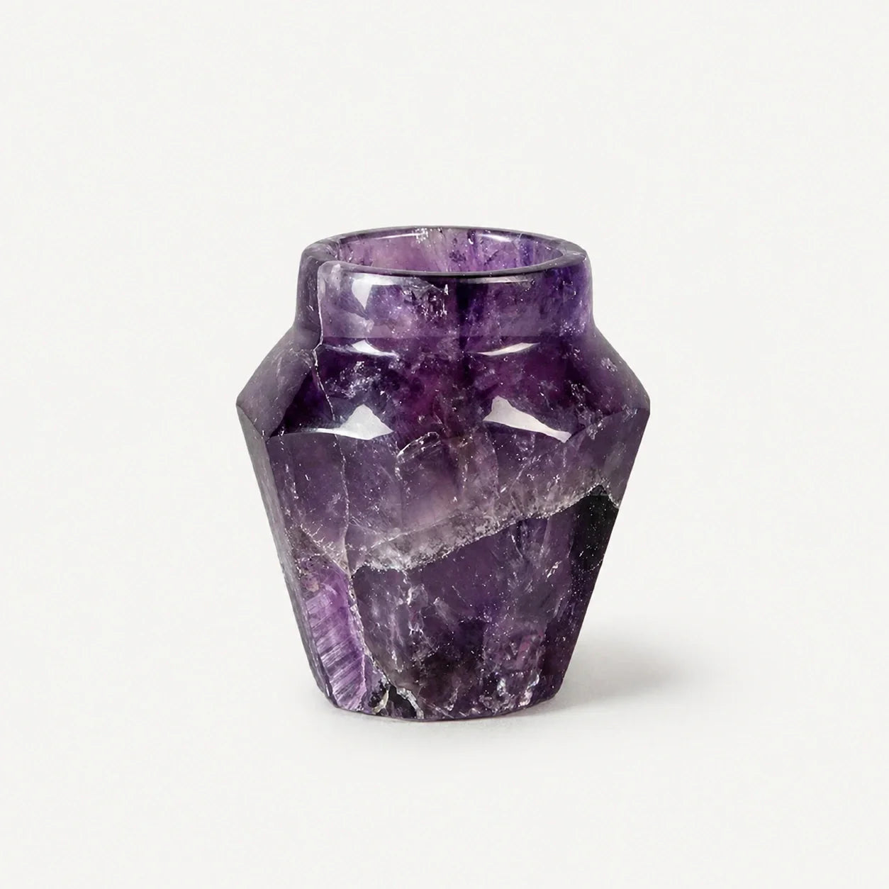 A single shot glass hand-carved from deep-violet natural amethyst crystal