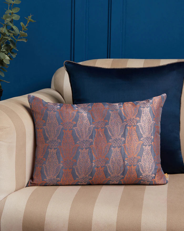 Anār indigo-and-coral silk pillow styled on a sofa — lifestyle view