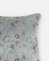 A macro close-up of the handloomed Tanchoi weave, showing the copper silk threads layered into a floral pattern.