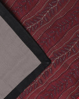 Corner detail of the contrast black border on the red silk runner