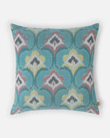 Hand-loomed silk ikat pillow in pastel blue and rose pink double ikat geometry.