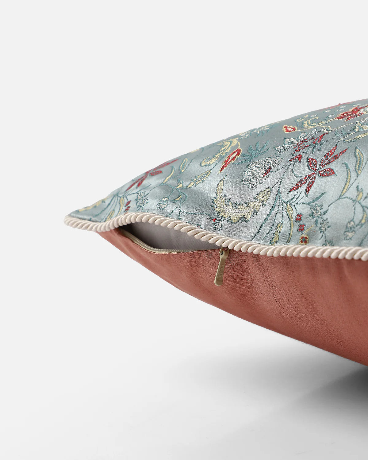 Detail view of the tailored rope-piped border framing the Bel & Burnished Copper pillow.