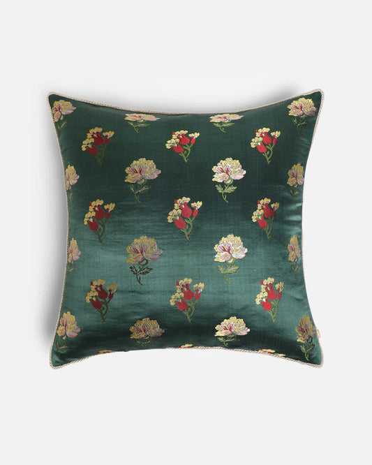 Gilded Emerald Green Gyasar silk pillow featuring hand-woven floral zari motifs on a deep emerald green background.