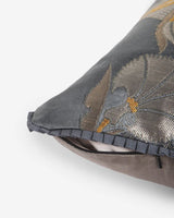 Close-up of the grey pleated architectural trim and hidden zipper closure on the Silver Laleh silk pillow.