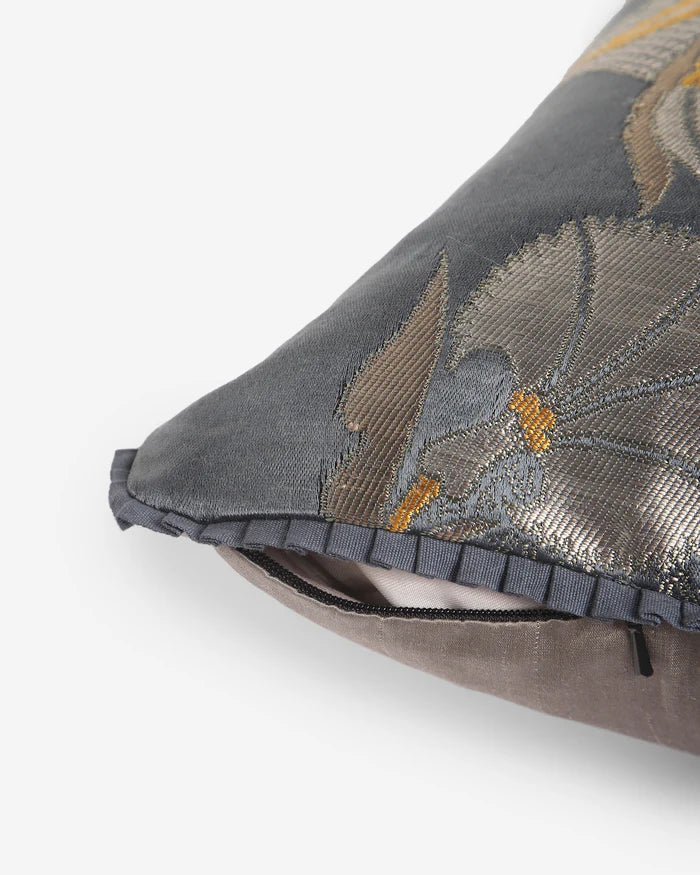 Close-up of the grey pleated architectural trim and hidden zipper closure on the Silver Laleh silk pillow.
