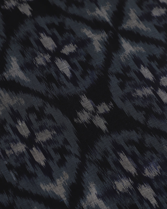 Close detail of woven indigo Pochampally ikat silk table runner, dyed before weaving
