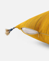 Side view showing the woven stripes, tassel and hidden zip