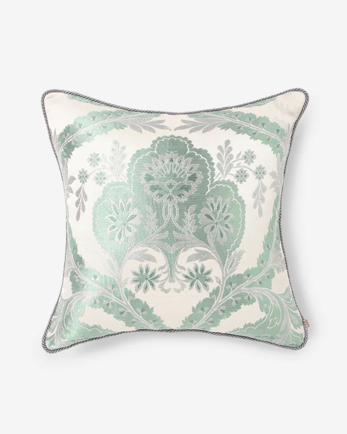 Front view of the Mint Silk Gyasar pillow featuring delicate silver and mint green motifs handwoven into cream silk.