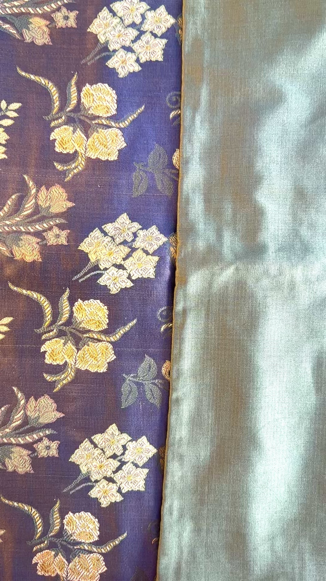 Cinematic reveal of the shimmering silk Tanchoi weave on the Banarasi Botanical pillow, showing the slate blue and seafoam faces.