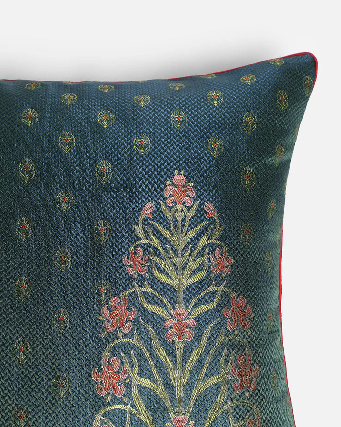 Extreme close-up of the intricate Iris floral pattern handwoven in rose, coral, and gold silk threads using the traditional Banarasi Gyasar technique.