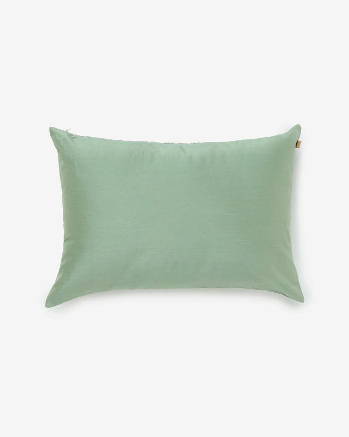 The minimalist reverse side of the Gol pillow in a solid, luminous sage green silk.