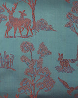 Close-up detail of deer, trees and hares woven into the Tanchoi teal silk, not printed.