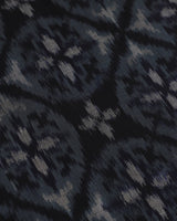 Macro view of the black and grey geometric double ikat motifs on the Tides silk table runner.