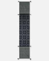 Full view of the 72-inch Tides table runner showcasing the transition between black double ikat motifs and blue striped ends.
